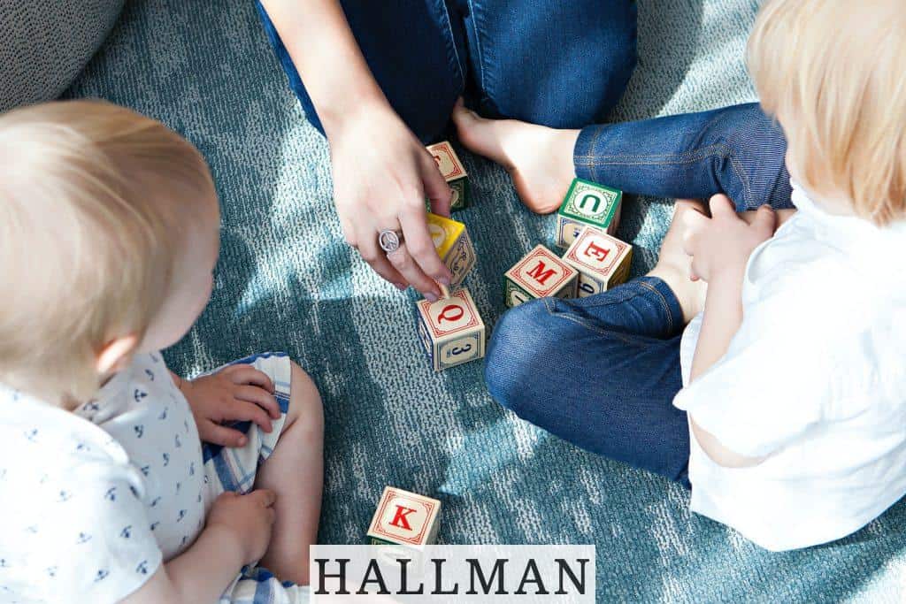 two toddler playing letter cubes