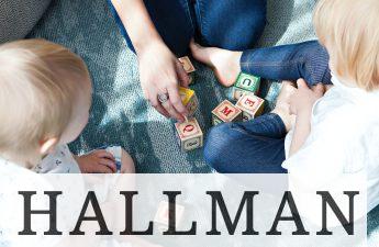 two toddler playing letter cubes