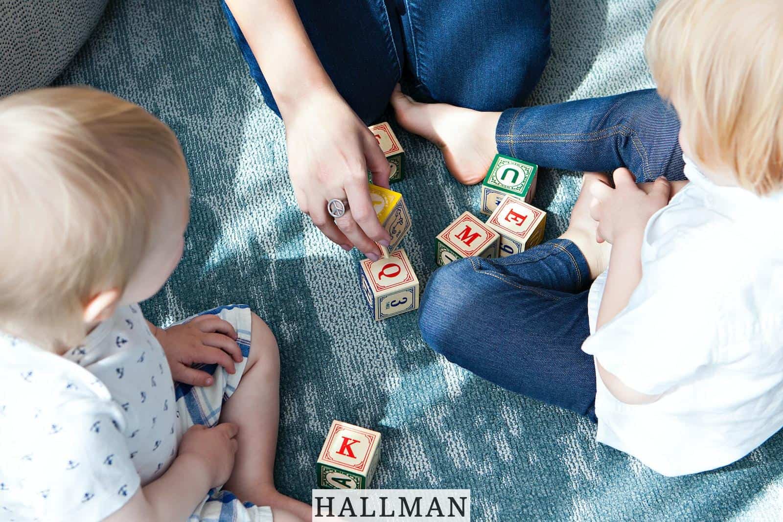 two toddler playing letter cubes