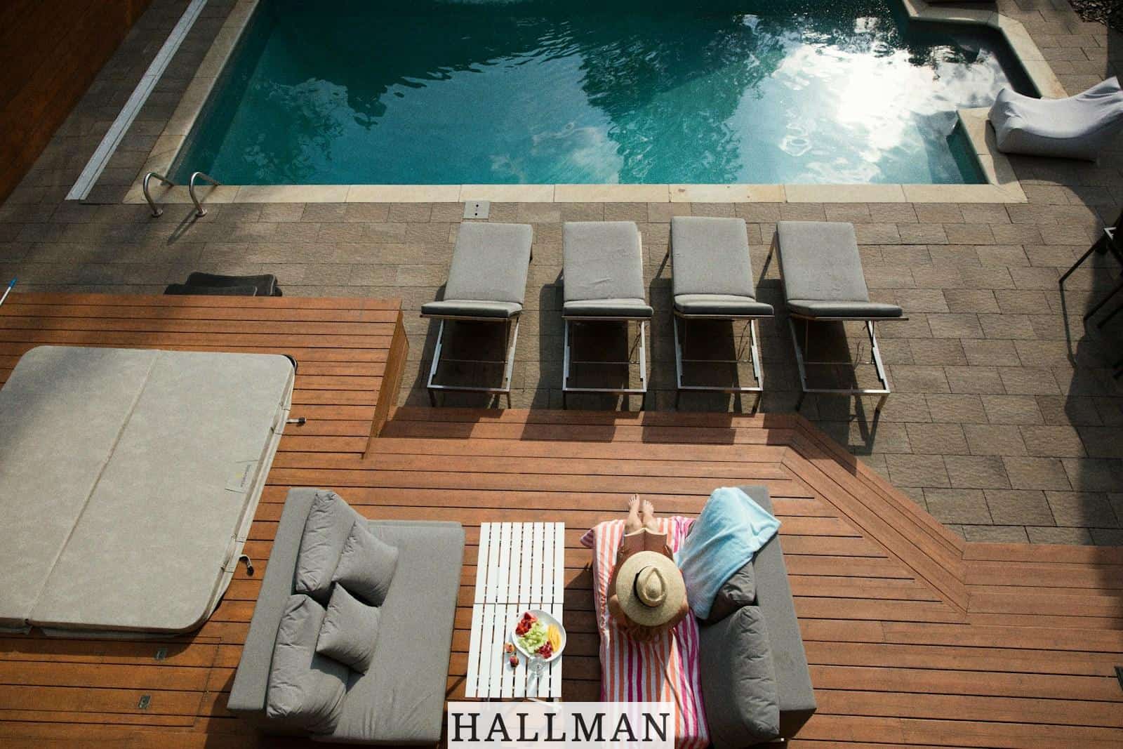 four gray loungers near pool