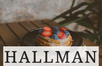 a stack of pancakes with strawberries and blueberries on top